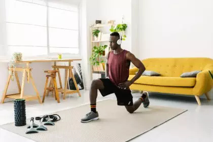 Young african man exercising doing fitness workout at home