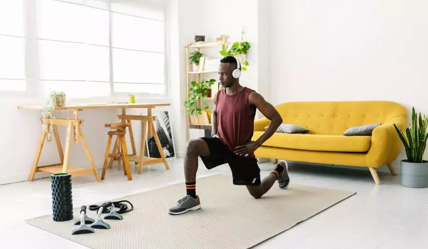 Young african man exercising doing fitness workout at home